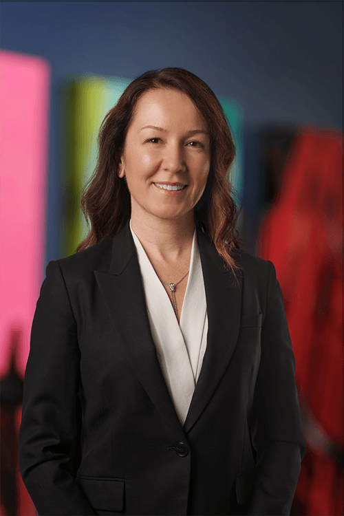 A professional headshot of Elif Balkas, our Chief Technology Officer
