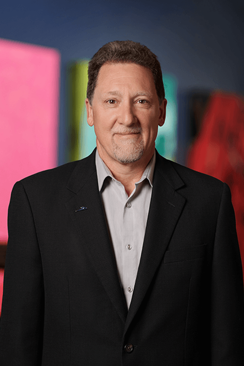 A professional headshot of John Edmond, our Co-Founder & Research Fellow
