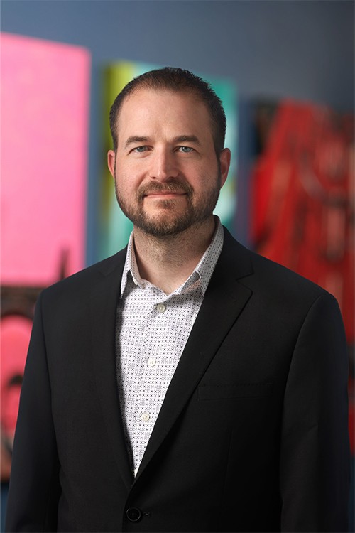 A professional headshot of Adam Milton, our SVP, Global Materials Operations